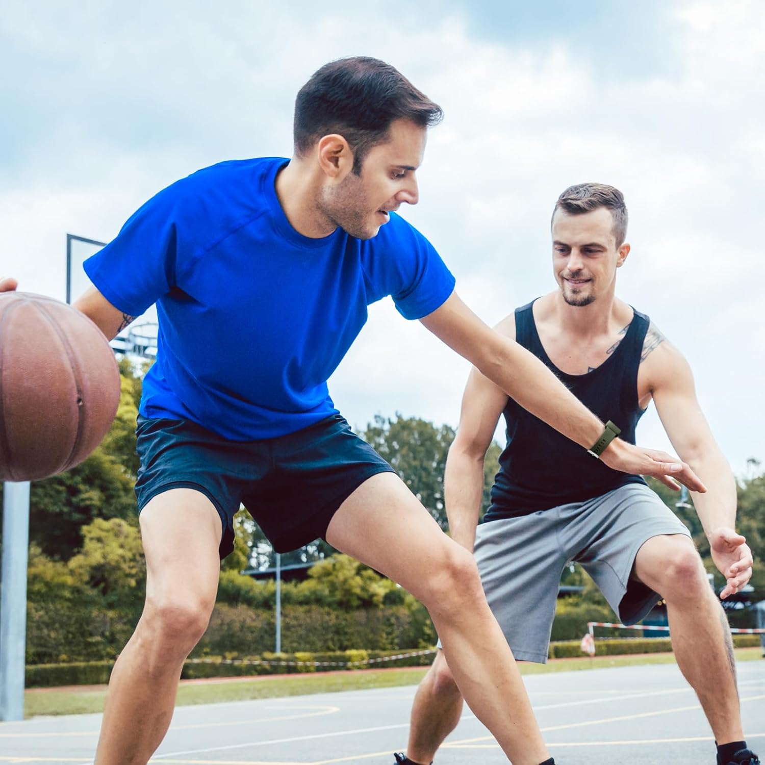 Men playing basketball while wearing the Whoop band