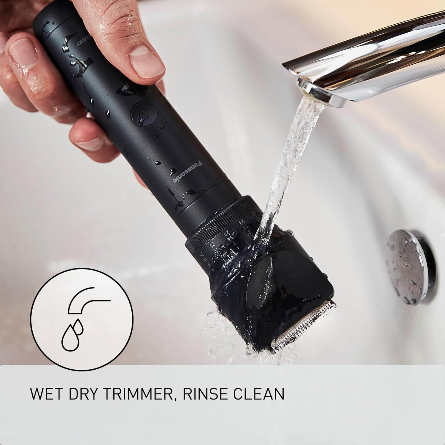 Panasonic MultiShape Trimmer being rinsed under running water in a sink.
