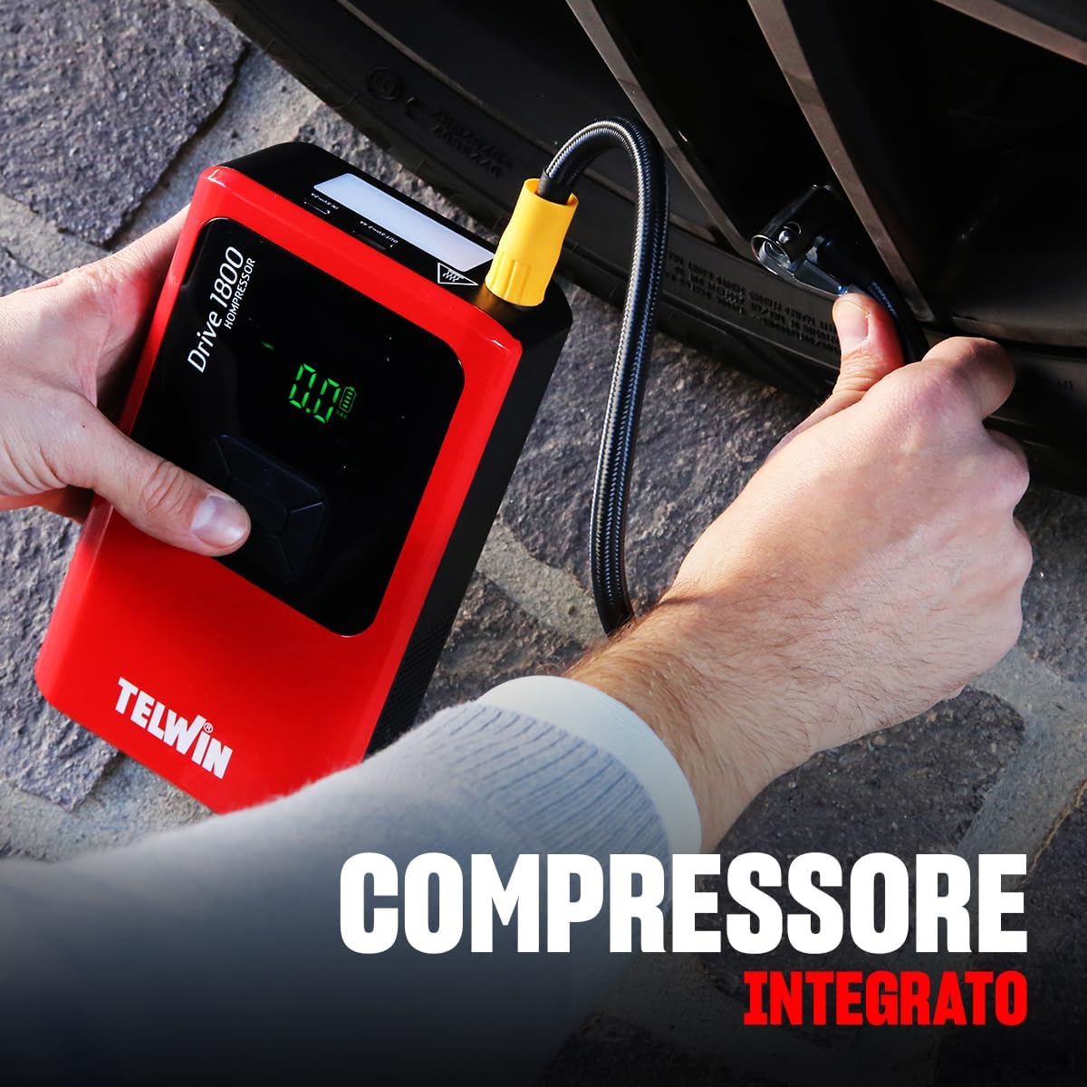 Telwin Drive 1800 Kompressor being used to inflate a car tire.