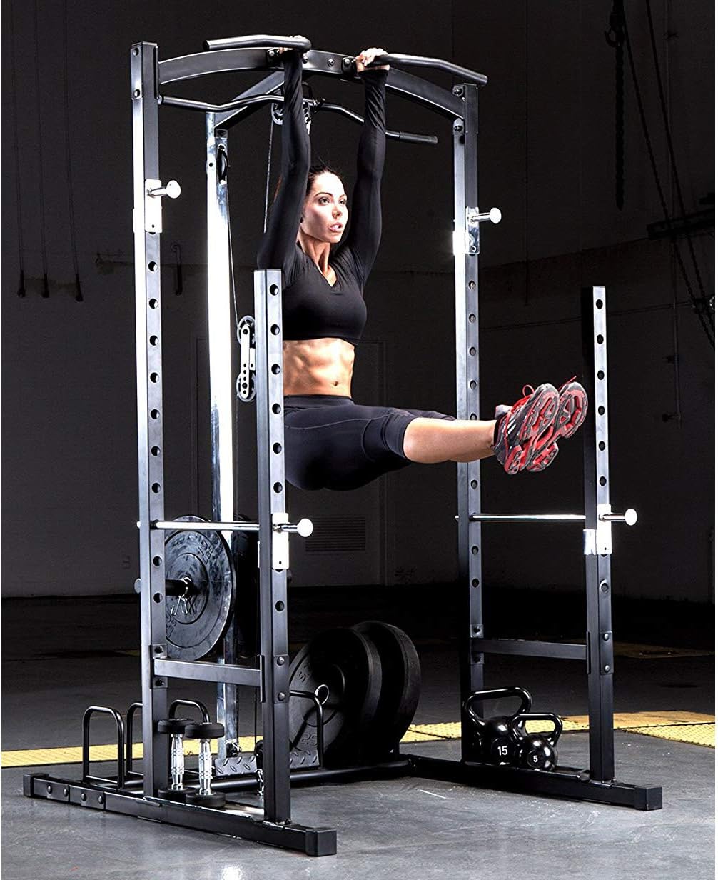 Woman performing hanging leg raises from the pull-up bar of the power cage.