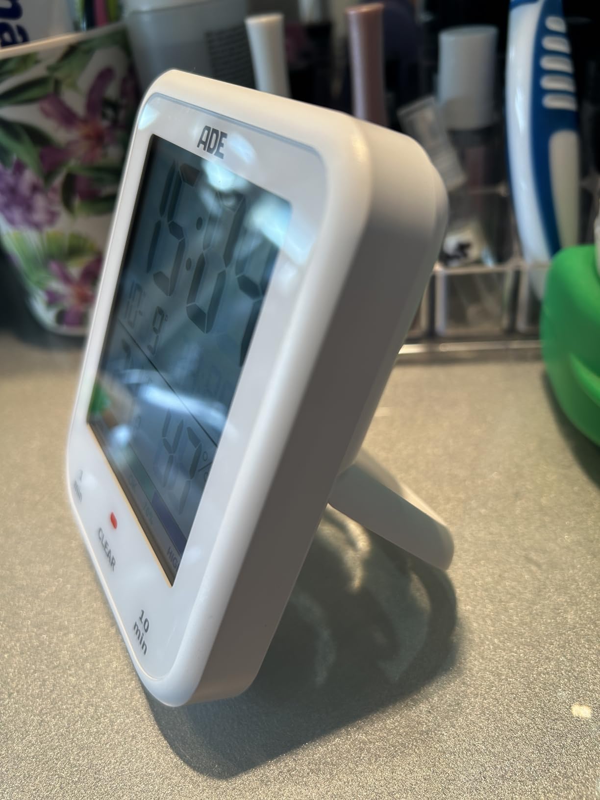 ADE CK2304 clock mounted on a wall using suction cups
