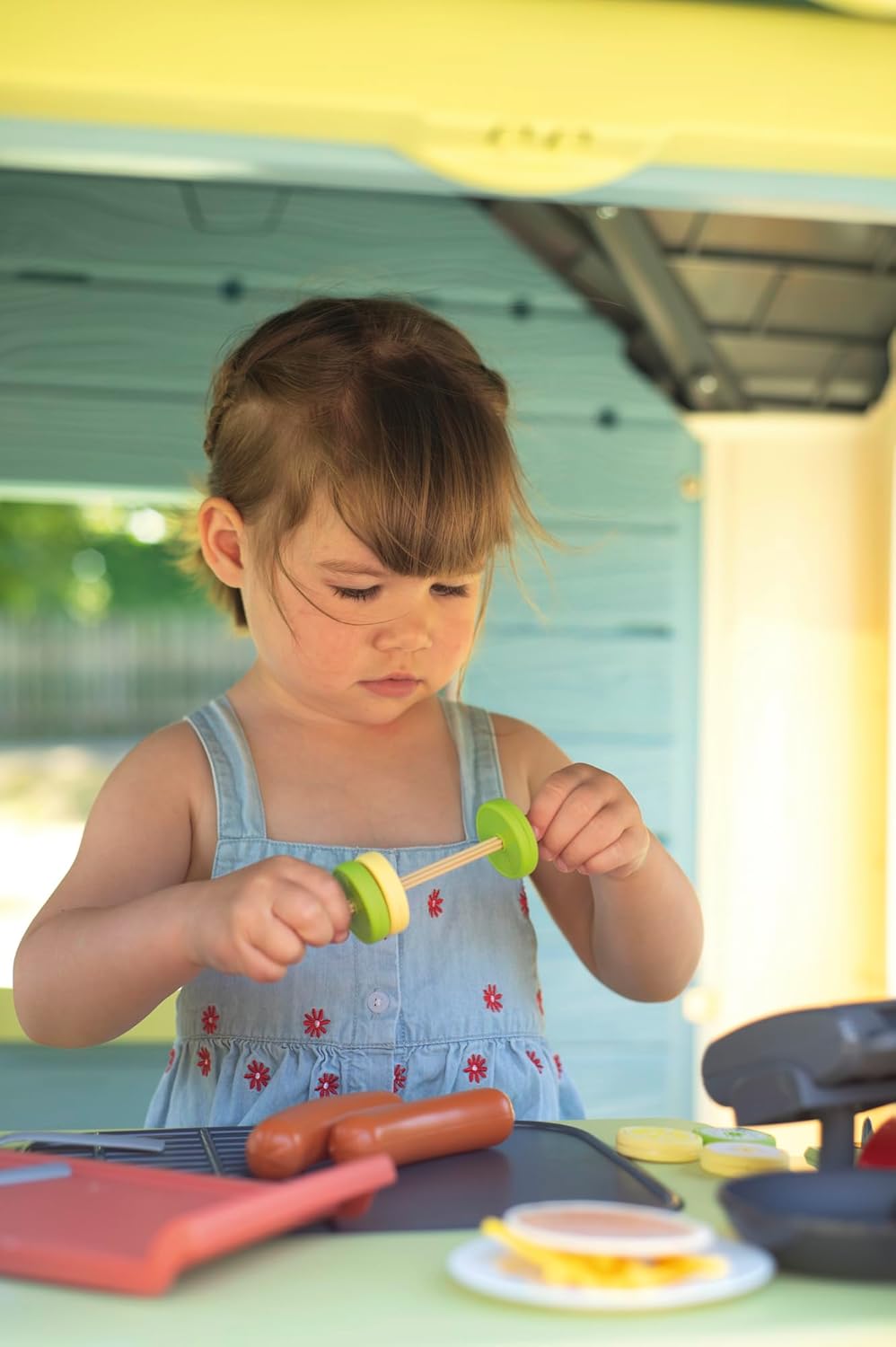 Child using the cash register in the Smoby Life Chef House