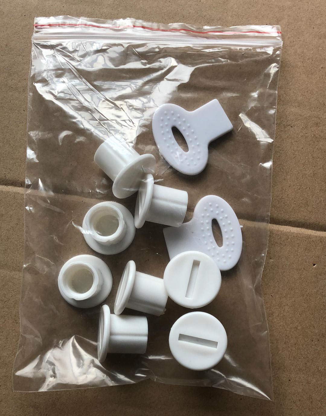 Eight white plastic screws and two white plastic screwdrivers sealed in a clear plastic bag.
