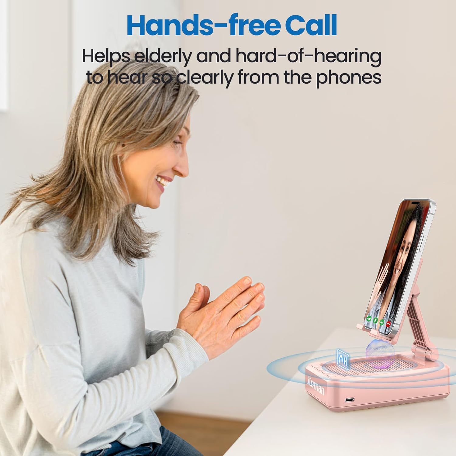 Image of an elderly woman using the JTEMAN Cell Phone Stand with Bluetooth Speaker for a hands-free call, showing sound waves emanating from the device.