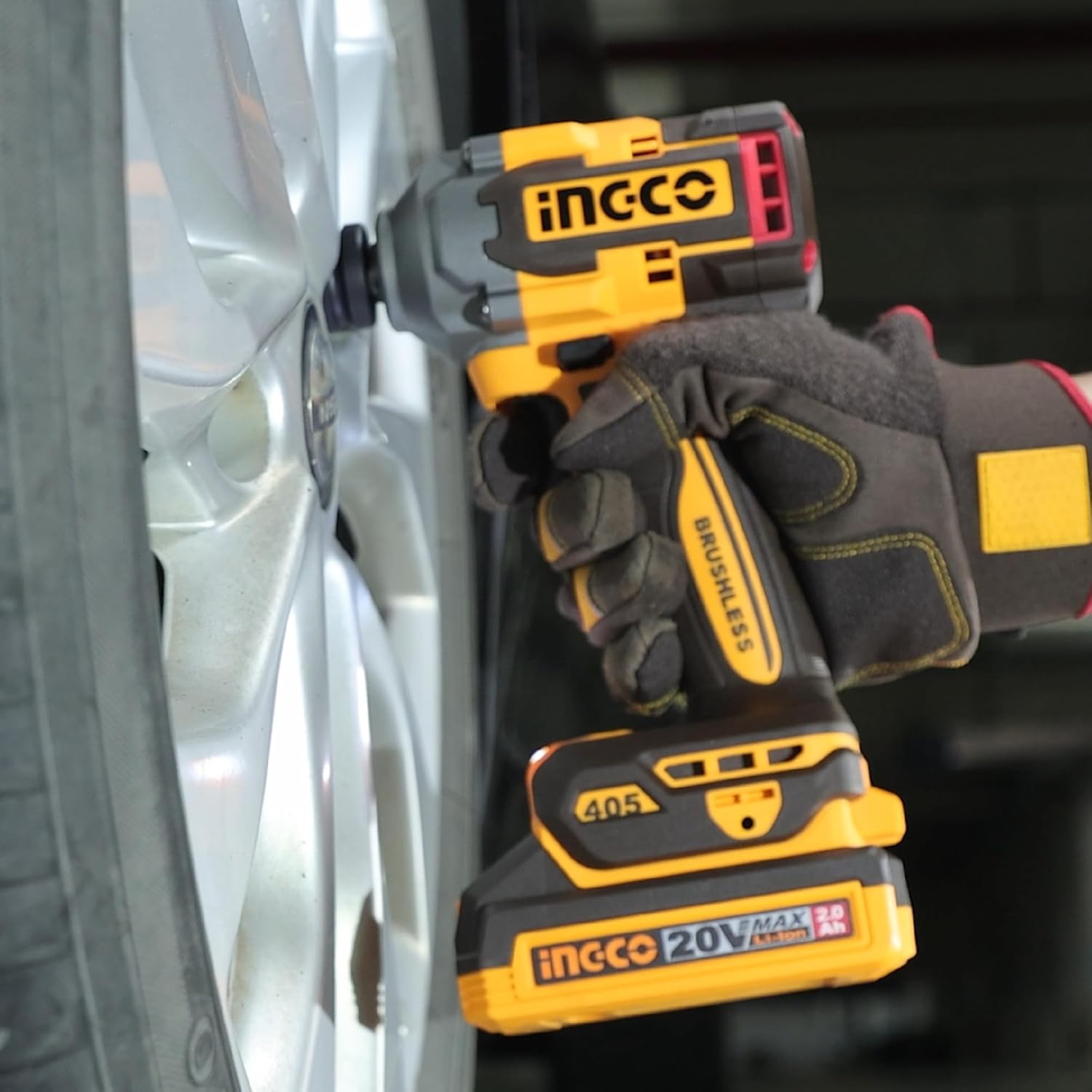 Ingco 20V Cordless Impact Wrench being used to tighten a lug nut on a car wheel