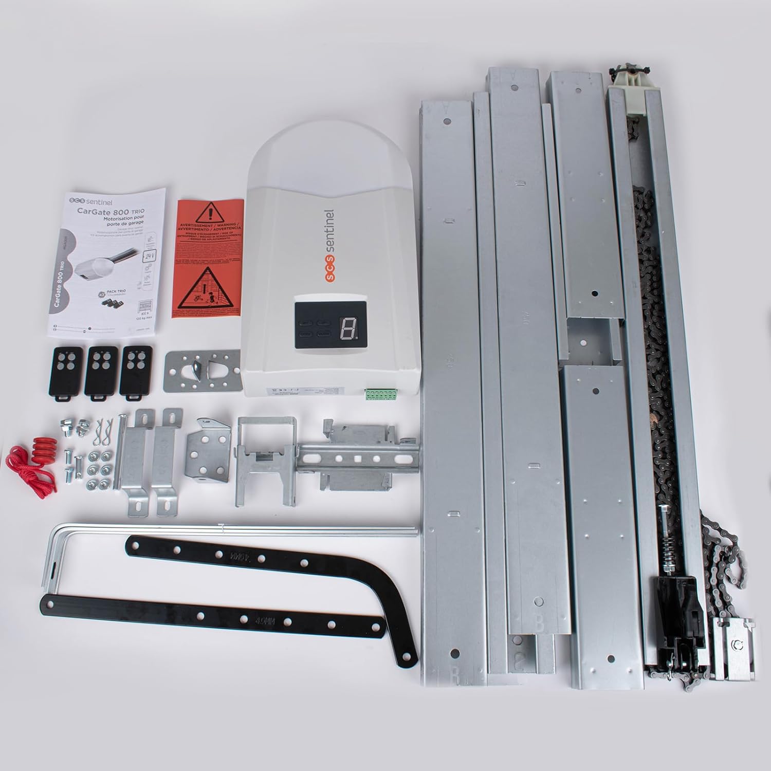 All components of the SCS Sentinel CarGate 800 Trio Garage Door Drive laid out on a white surface.