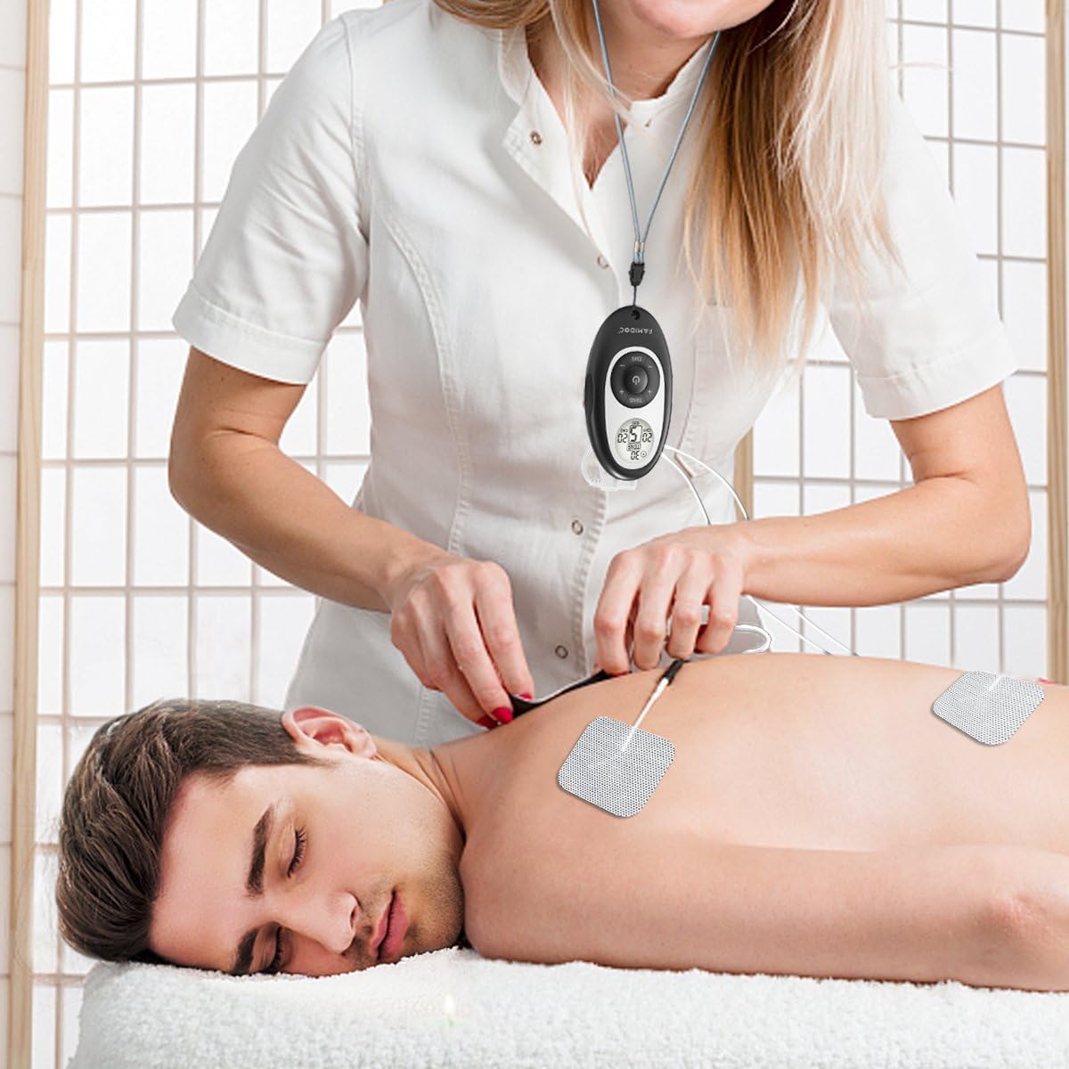 User applying electrode pads to lower back