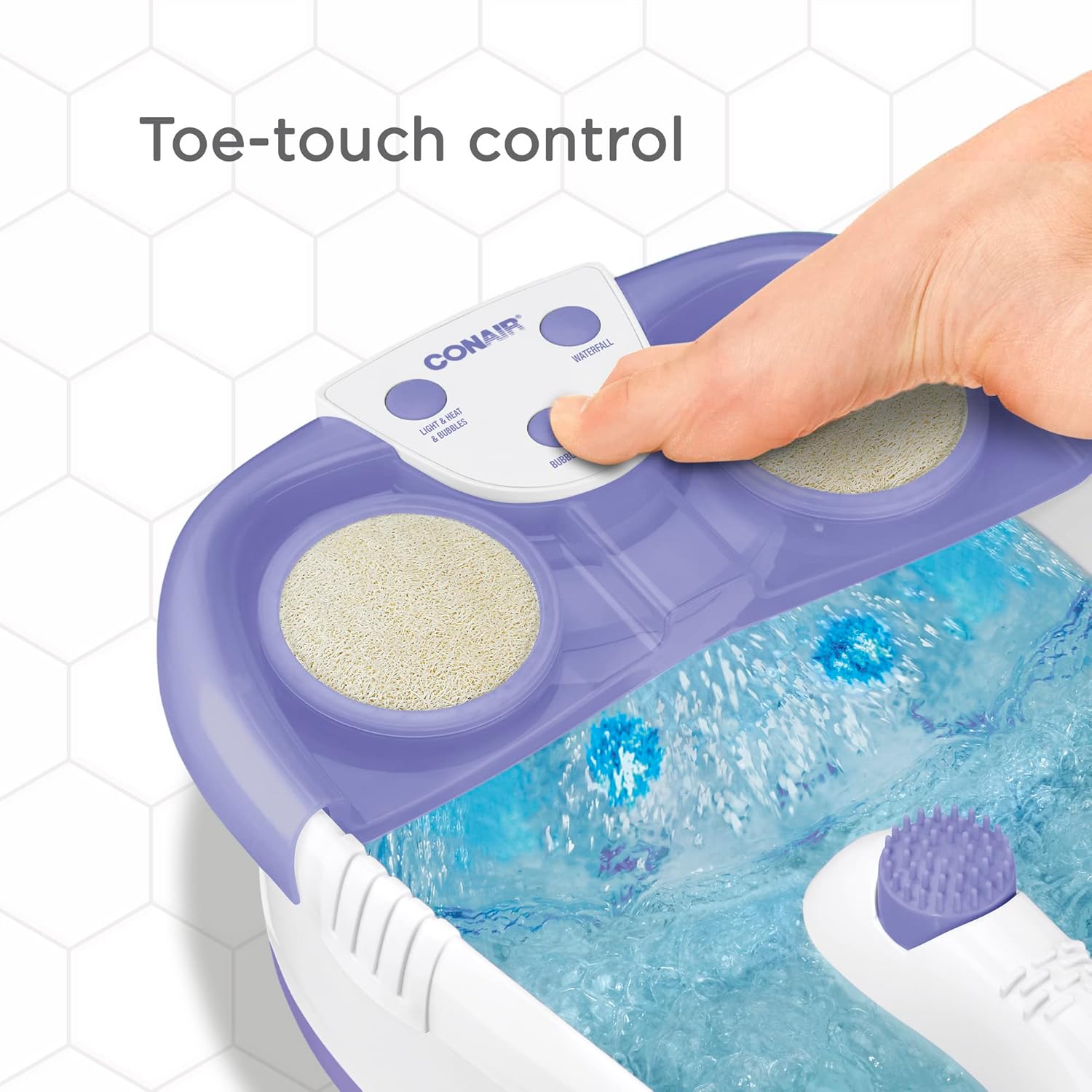 Close-up of a foot pressing the toe-touch controls on the Conair Foot Spa