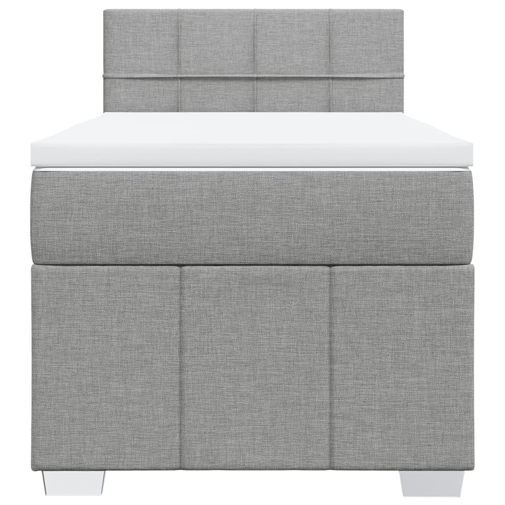 Łóżko kontynentalne 90 x 200 cm, jasnoszare z materacem ze sprężynami kieszeniowymi, miękkim obiciem z materiału, komfortowym topperem i oświetleniem LED do sypialni