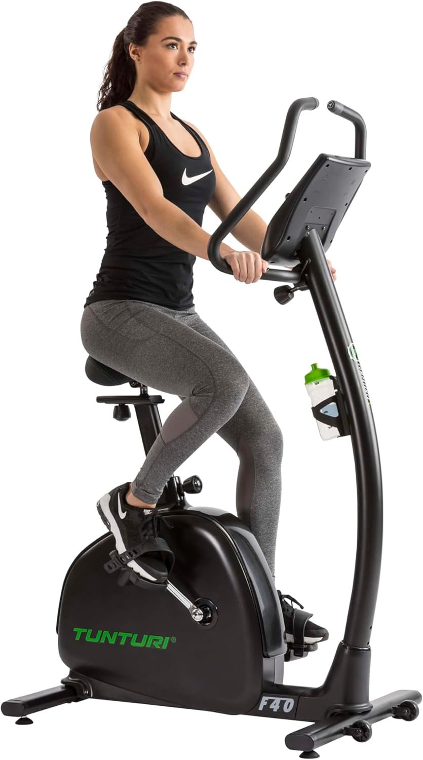 User exercising on the Tunturi F40 Competence Series Upright Exercise Bike, demonstrating proper posture and use.