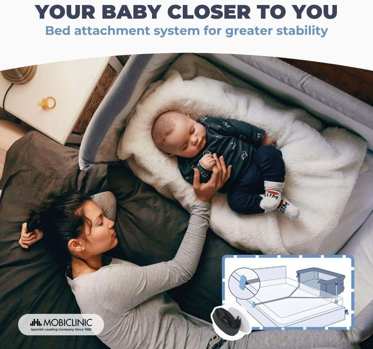 Mobiclinic Moon Bedside Sleeper attached to an adult bed with a baby sleeping inside