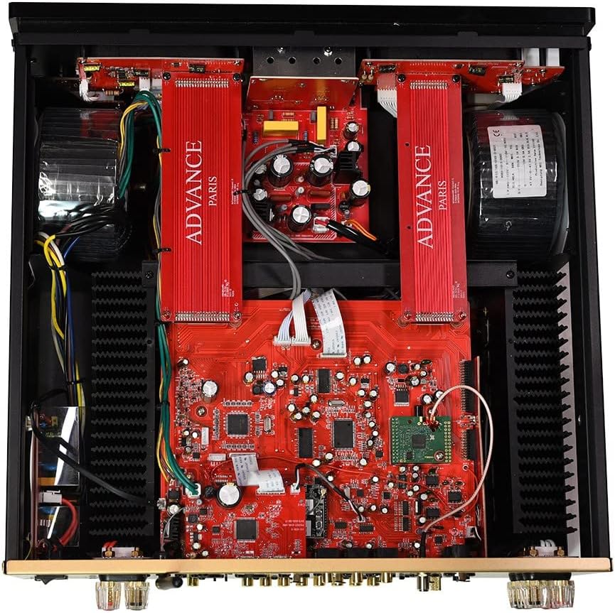 Top-down internal view of the Advance Paris A12 Classic amplifier, revealing the symmetrical layout of components, including heat sinks and circuit boards.