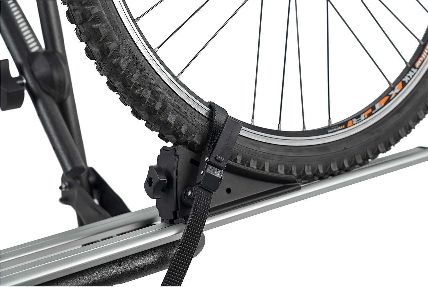 Close-up of a bike wheel secured by a strap on the rack