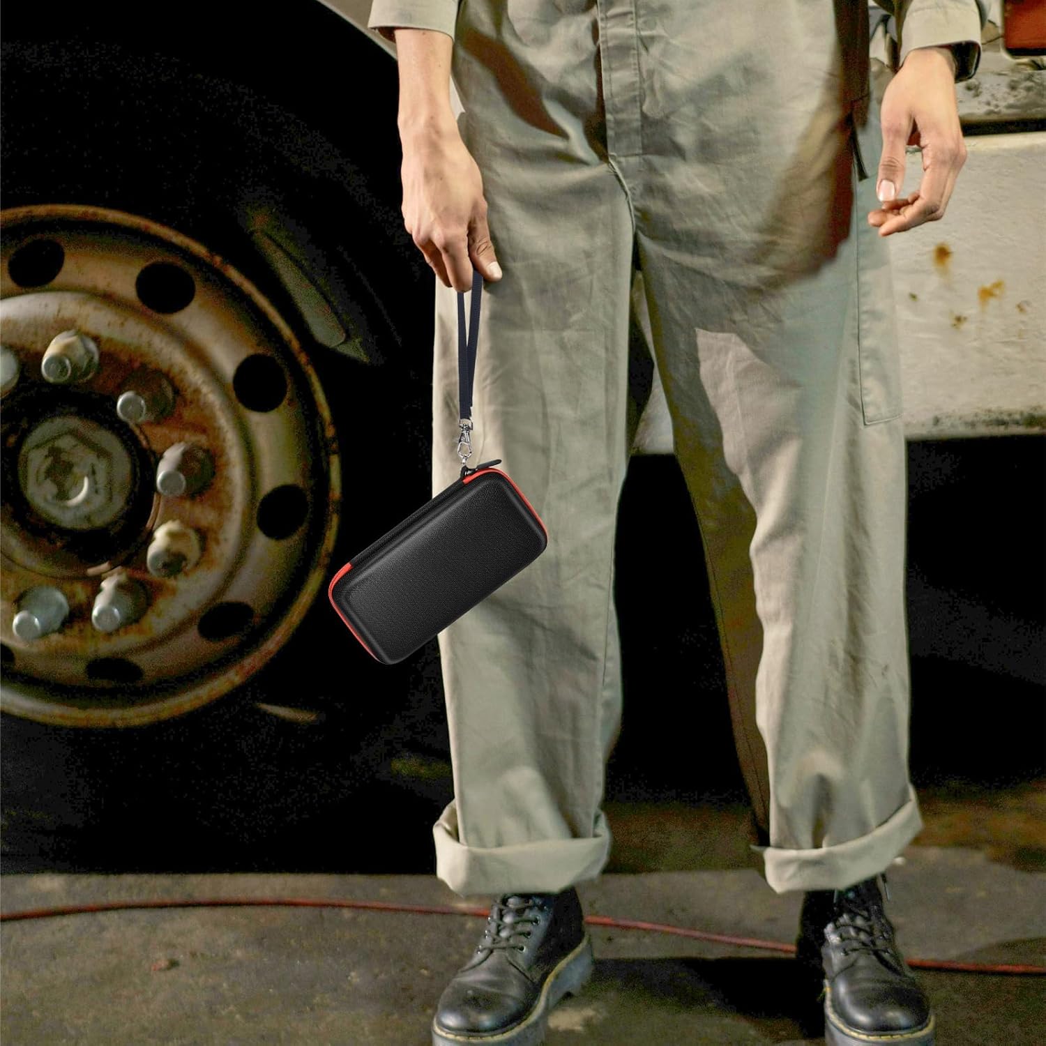 Person holding the Casmilee case by its hand strap, demonstrating portability