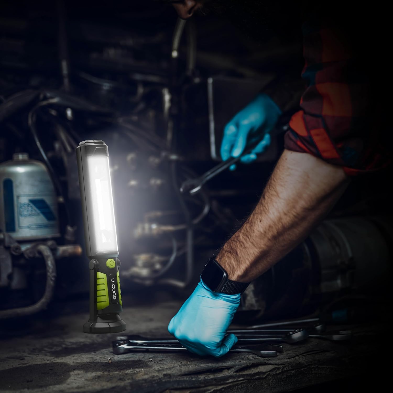 Person using Luceco LED flashlight in a workshop