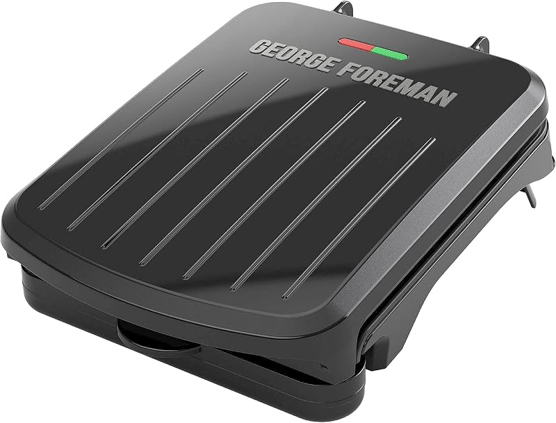 George Foreman Compact 2-Serving Electric Indoor Grill and Panini Press for 1–2 People, Classic Plates, Black | Compact grill with nonstick plates, panini mode, fat-removing slope and vertical storage.