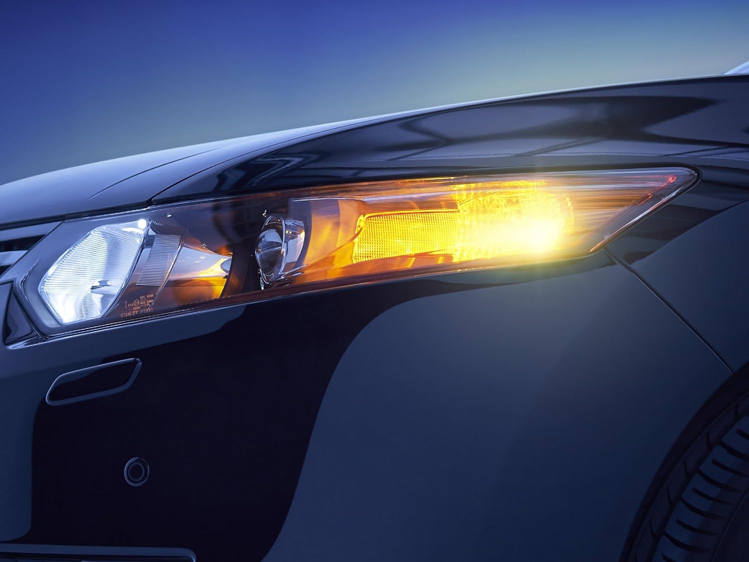 Front view of a car with an amber turn signal light illuminated