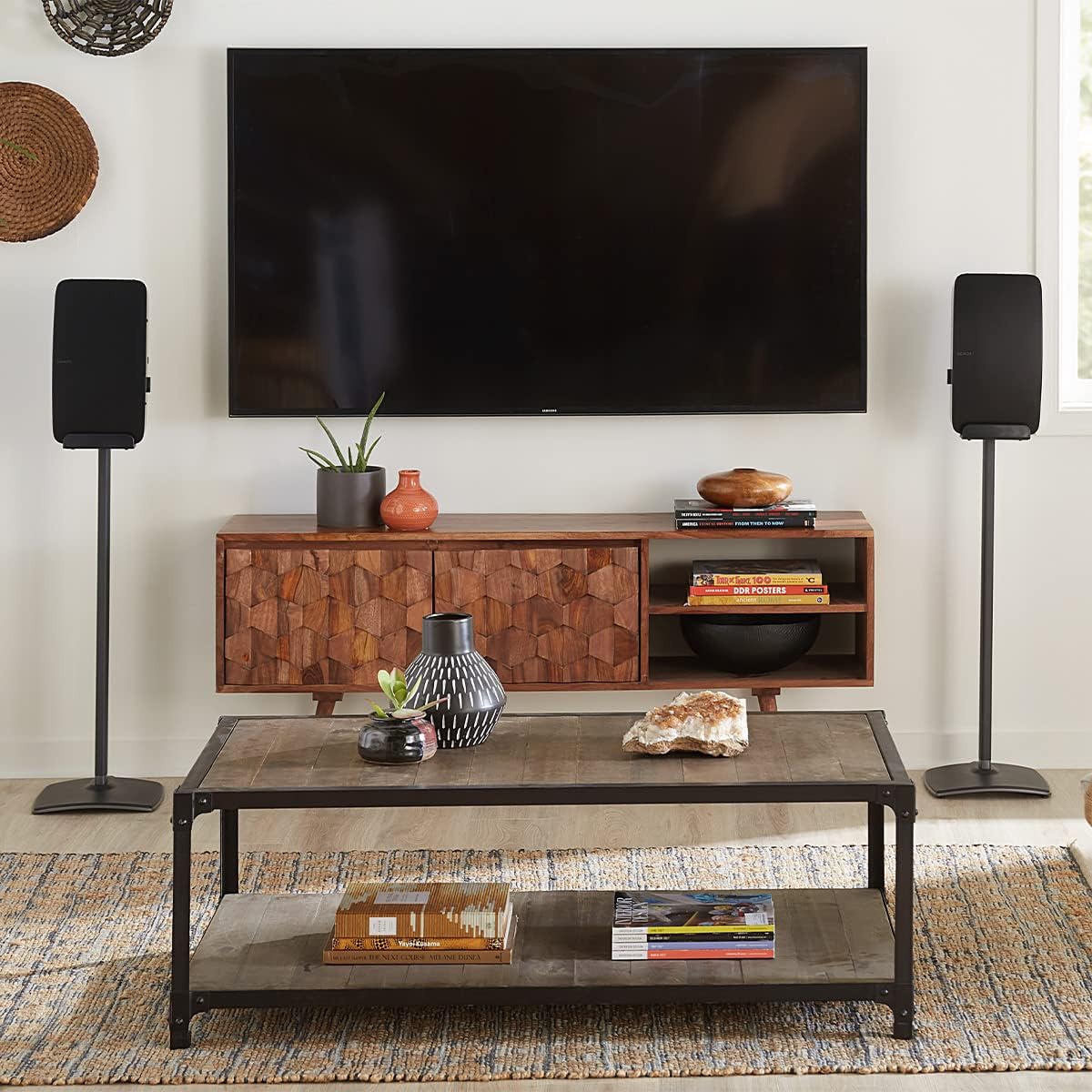 Two SANUS speaker stands with Sonos speakers in a living room