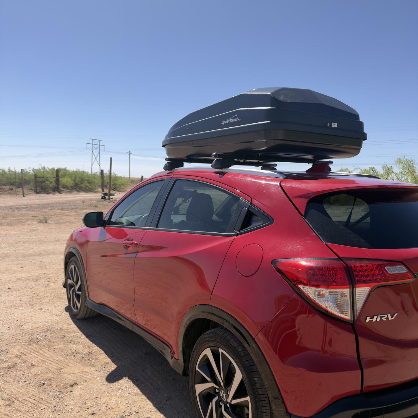 SportRack Vista XL mounted on white SUV in a forest setting