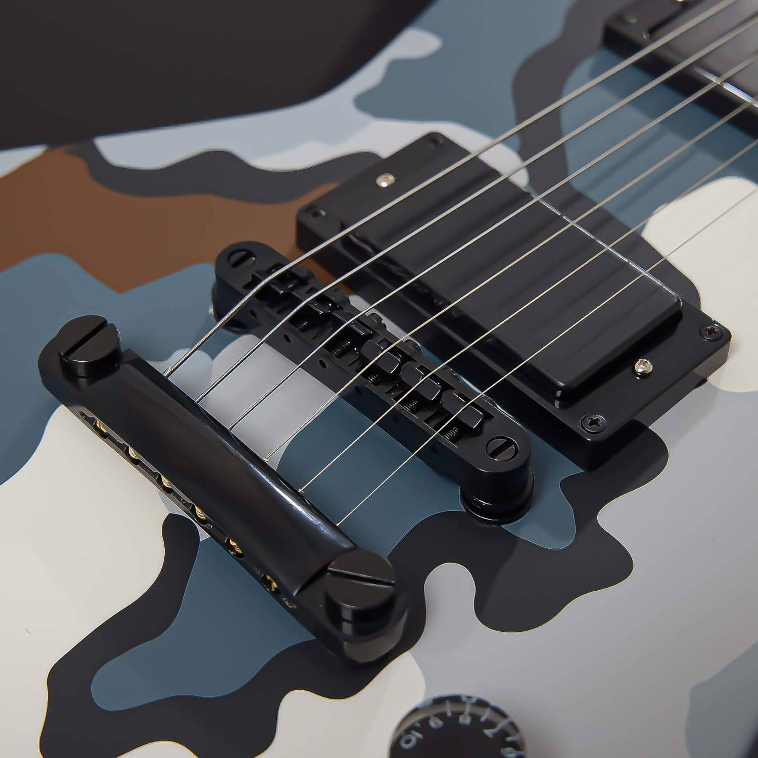 Close-up of Firefly FFLX guitar bridge, pickups, and control knobs