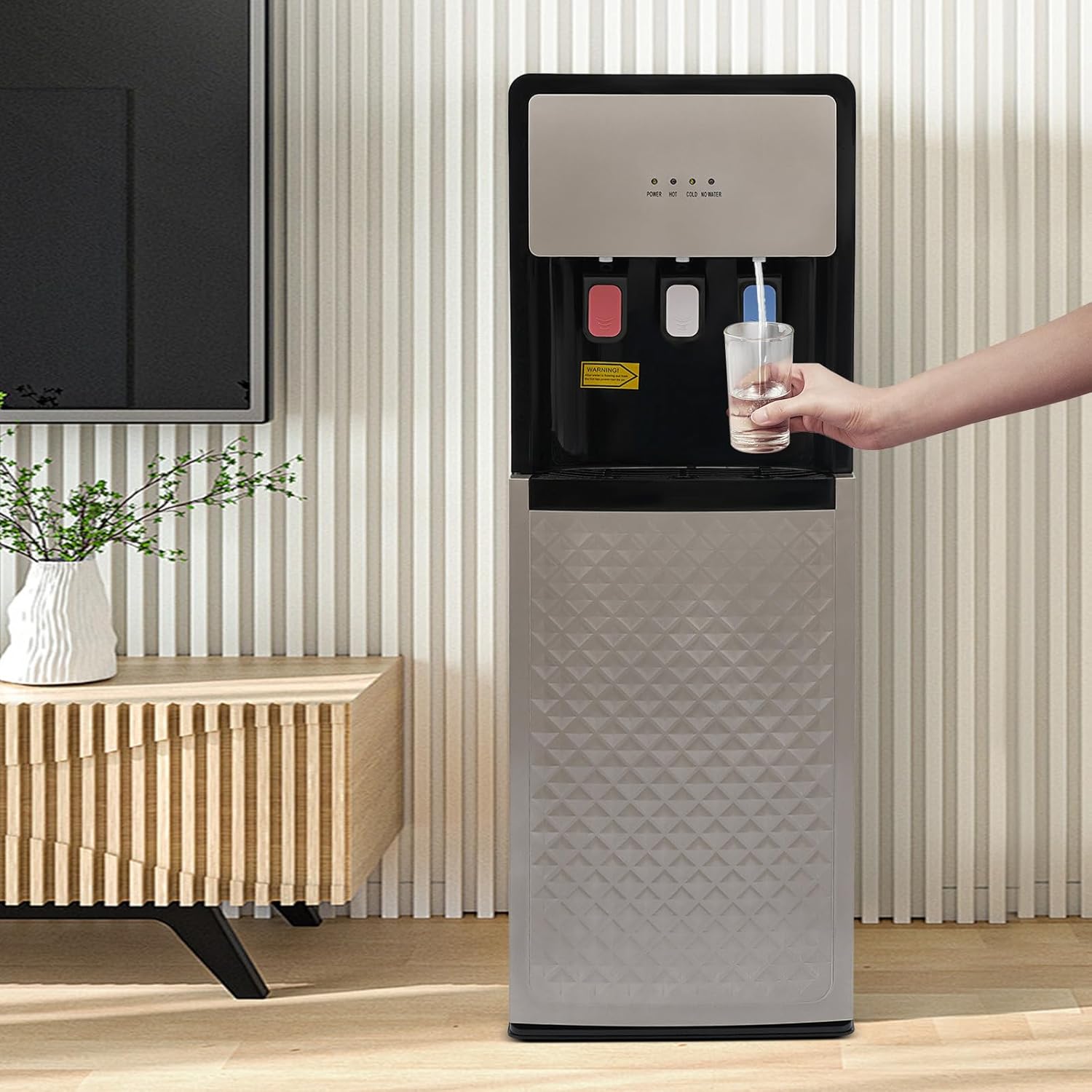 Person dispensing water from the dispenser into a glass
