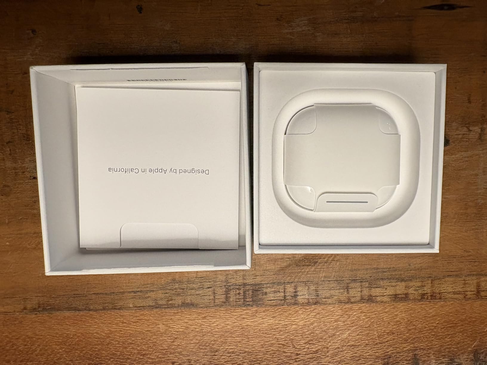 AirPods 4 sitting in their retail packaging