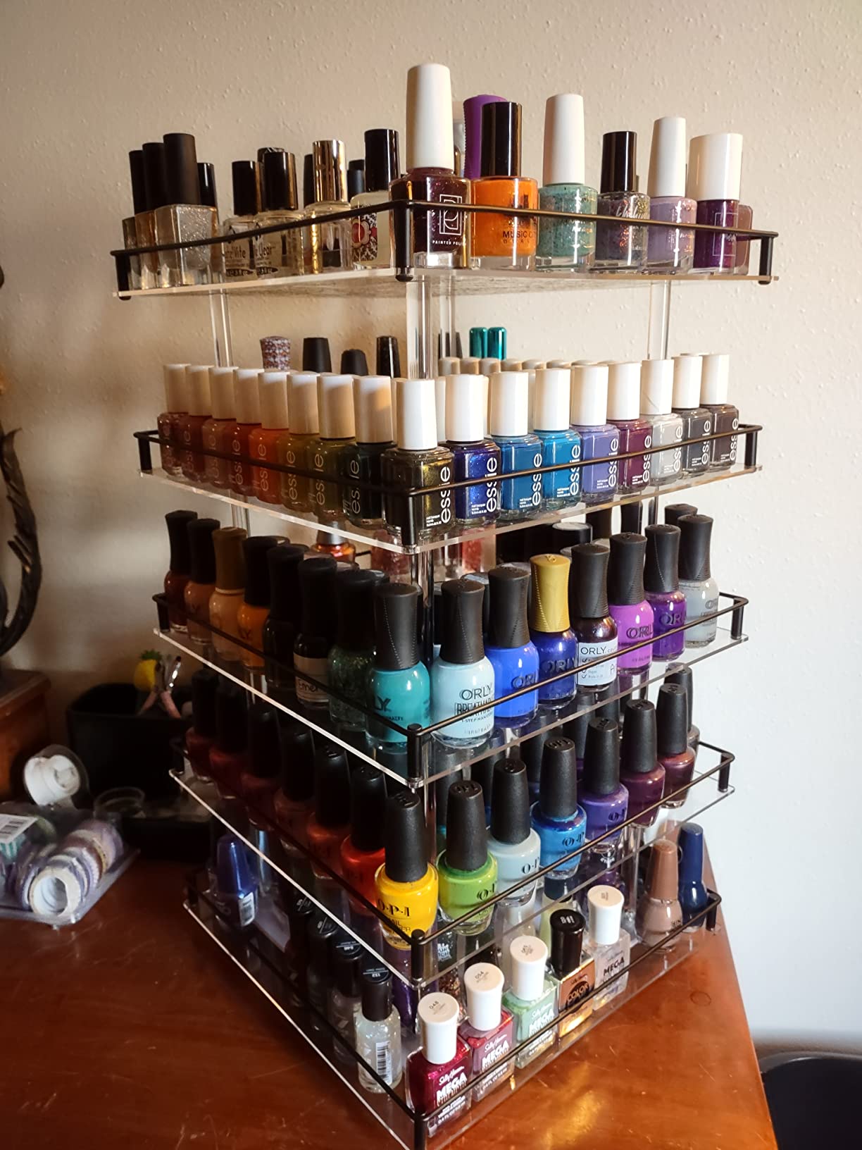 Rotating carousel nail polish organizer displaying bottles in a circle