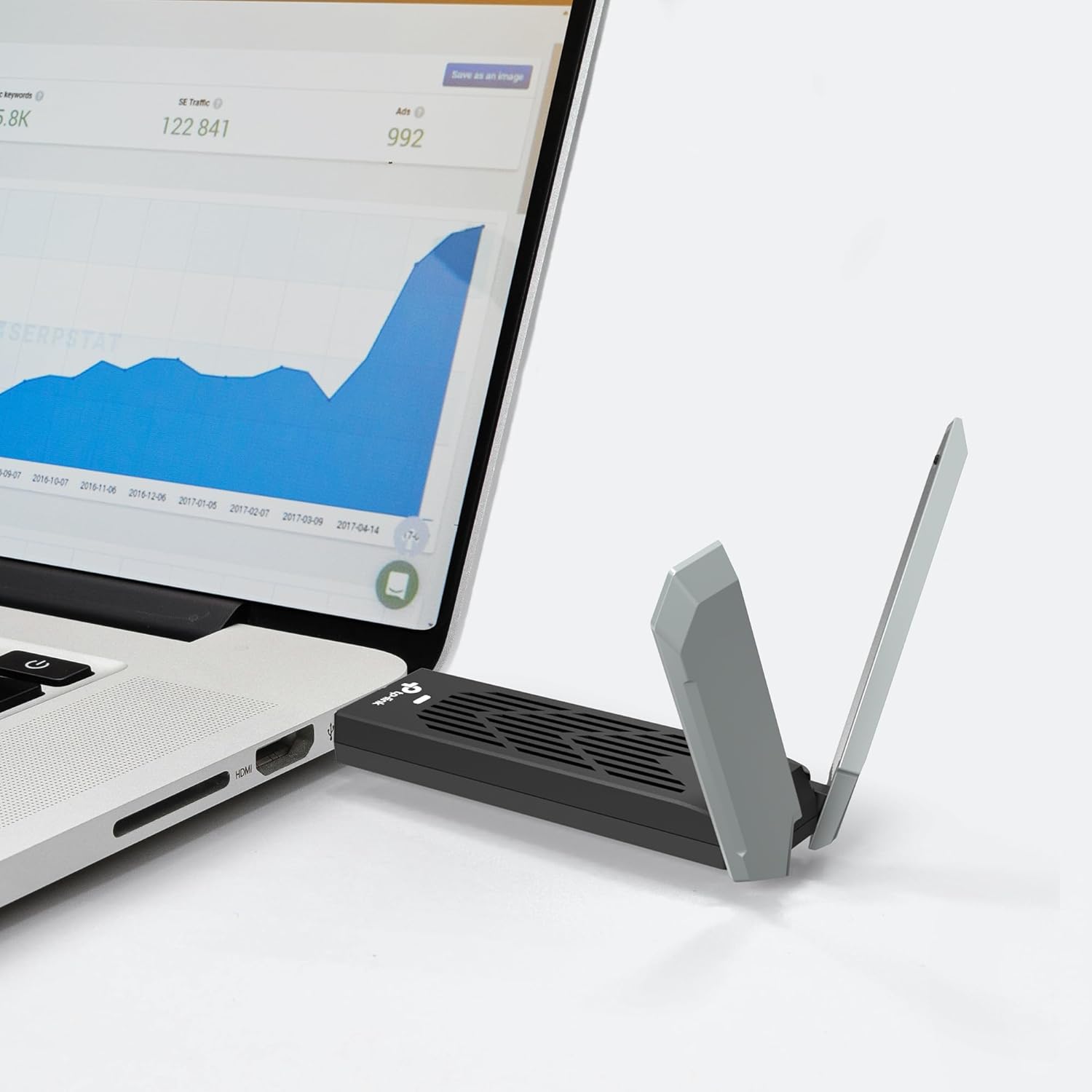 TP-Link Archer TBE401UH Wi-Fi 7 USB Adapter plugged directly into a laptop