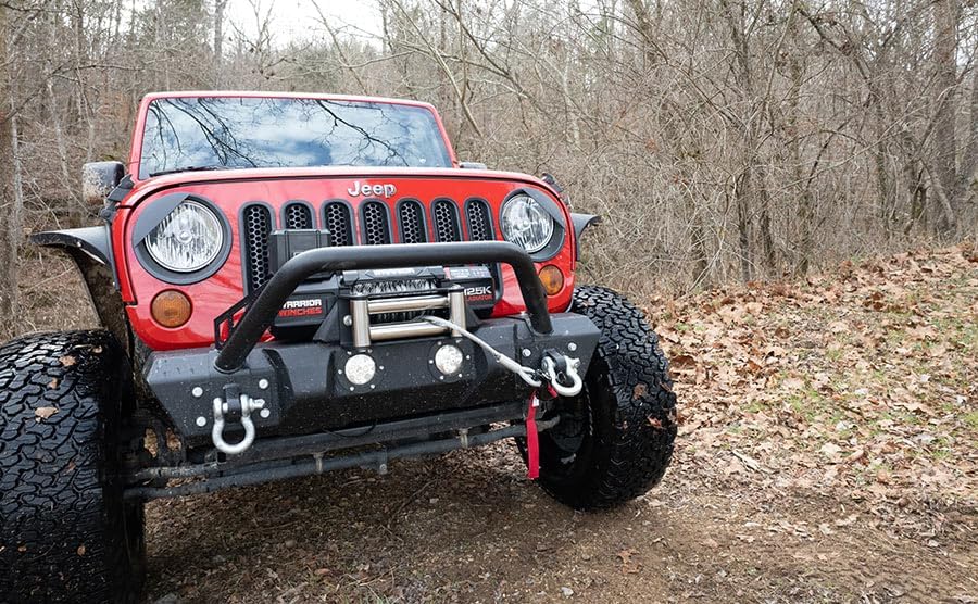 Gladiator winch installed on the front bumper of a red Jeep