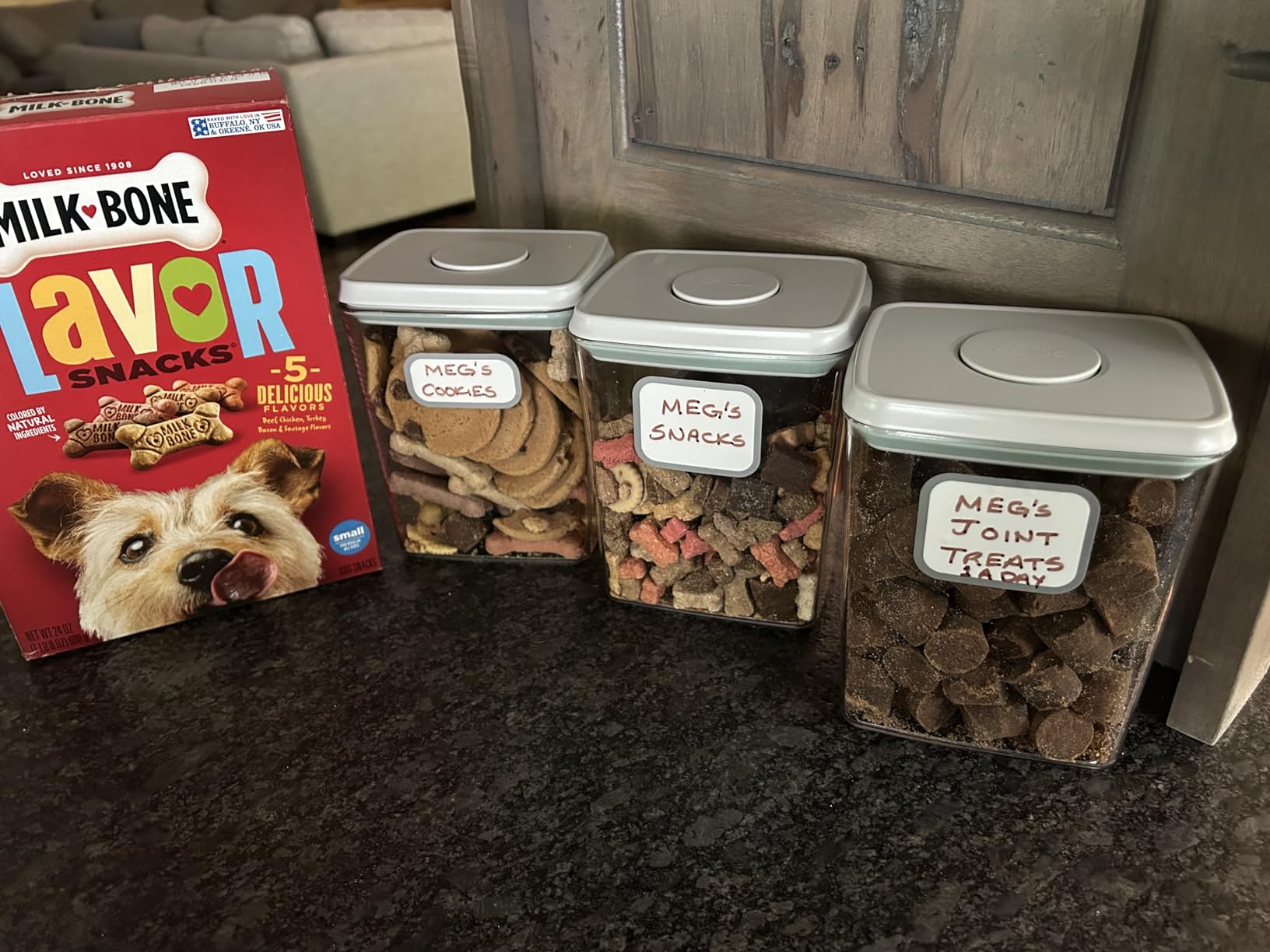 Airtight containers on a pantry shelf holding snacks and dry goods
