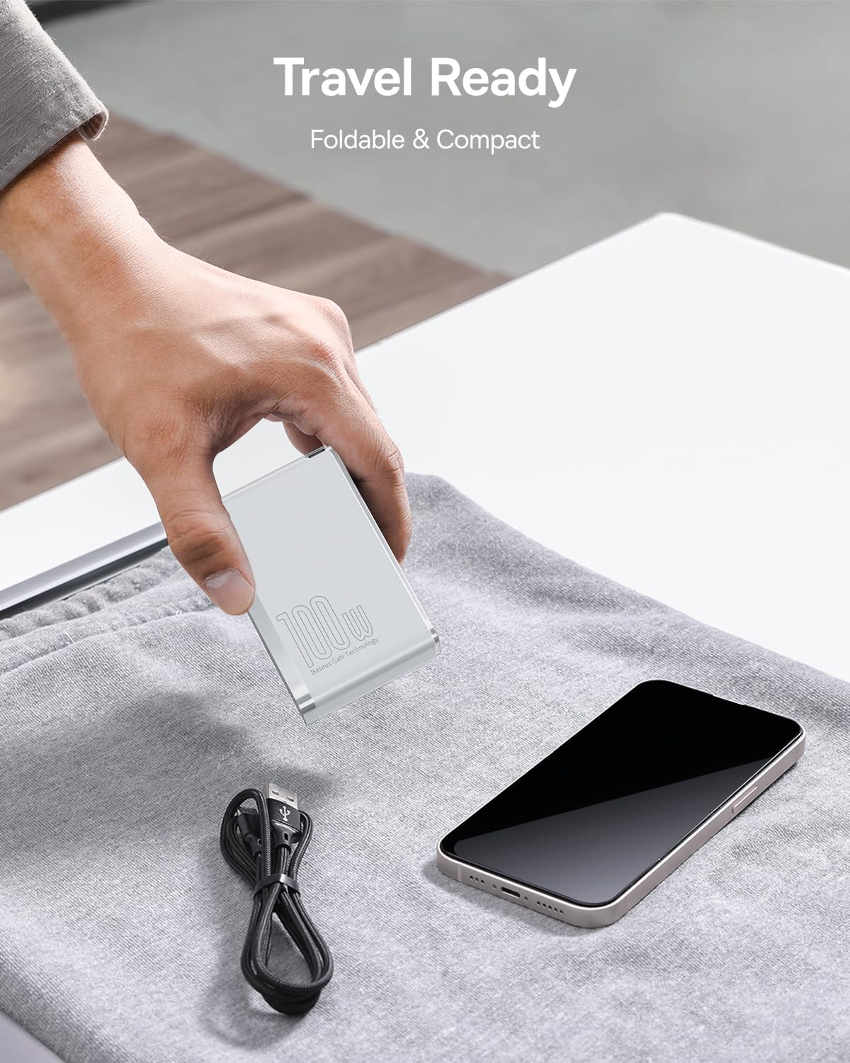 Baseus 100W charger being packed for travel