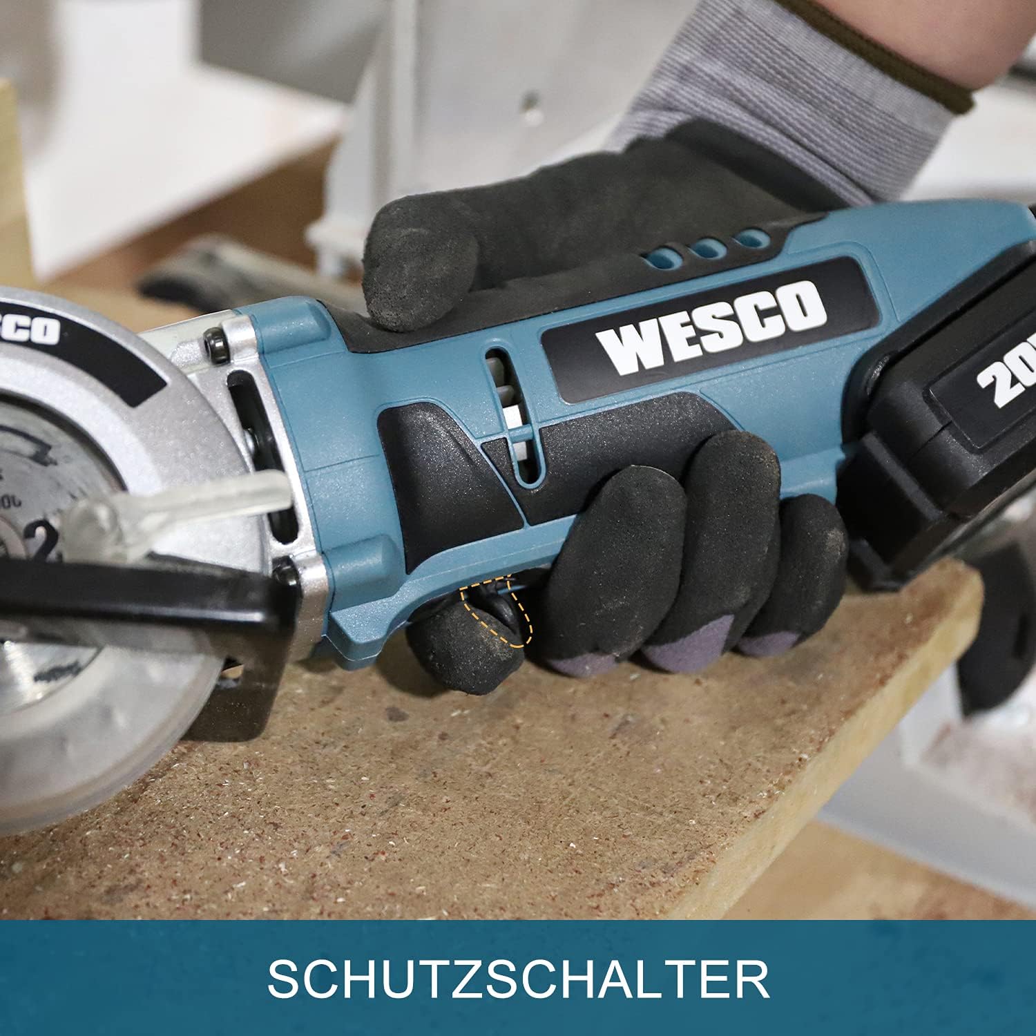 Close-up of the WESCO Mini Circular Saw handle, highlighting the safety switch mechanism.