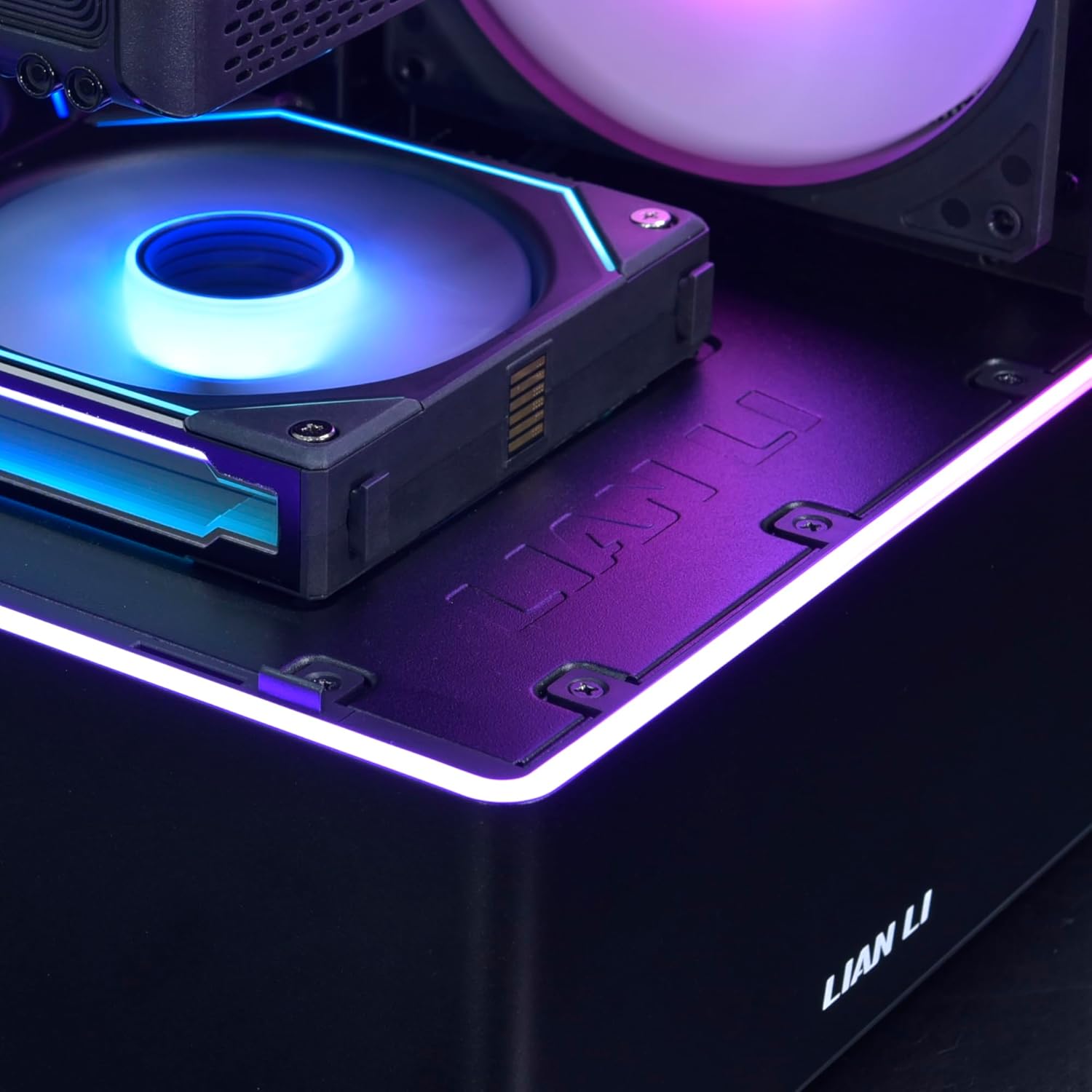 Close-up of the bottom front of the PC case showing the RGB light strip and fan lighting