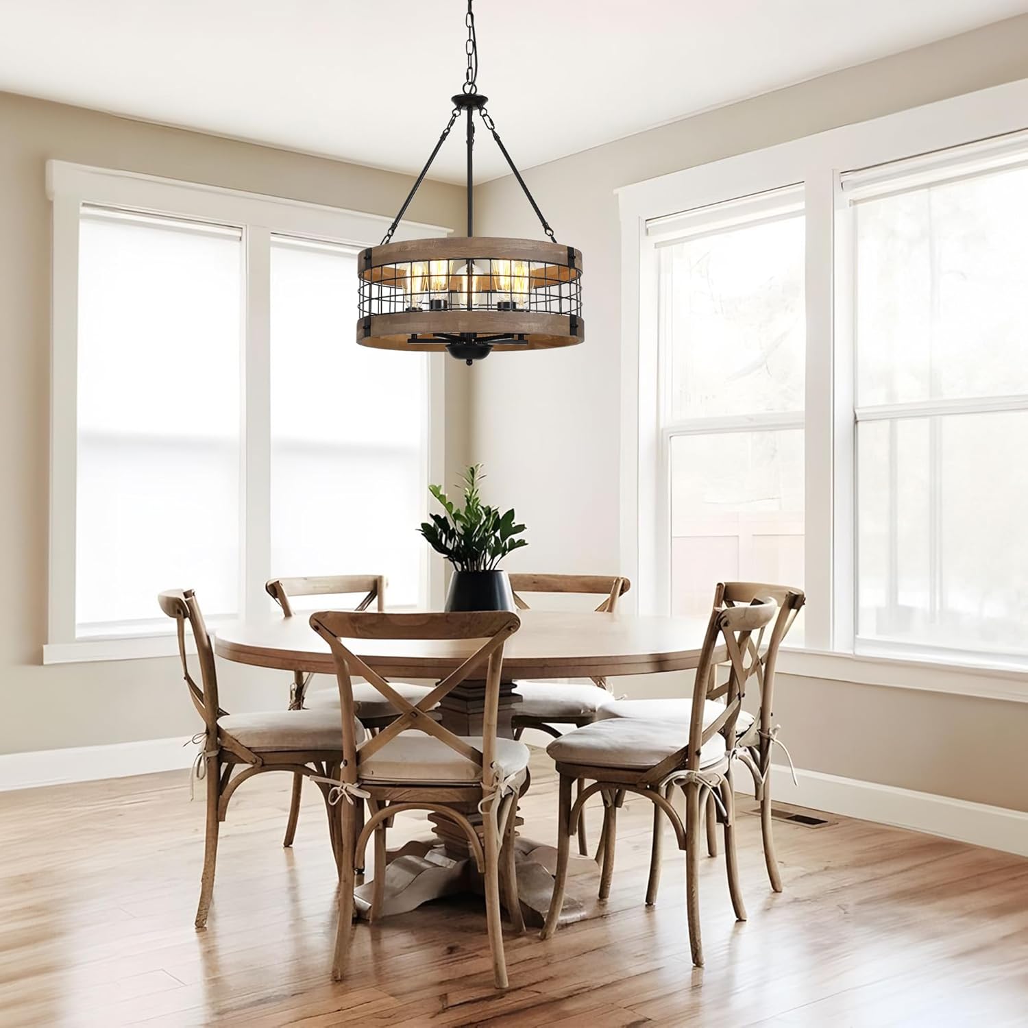 LamQee farmhouse chandelier installed in a dining room with a round table and cross-back chairs