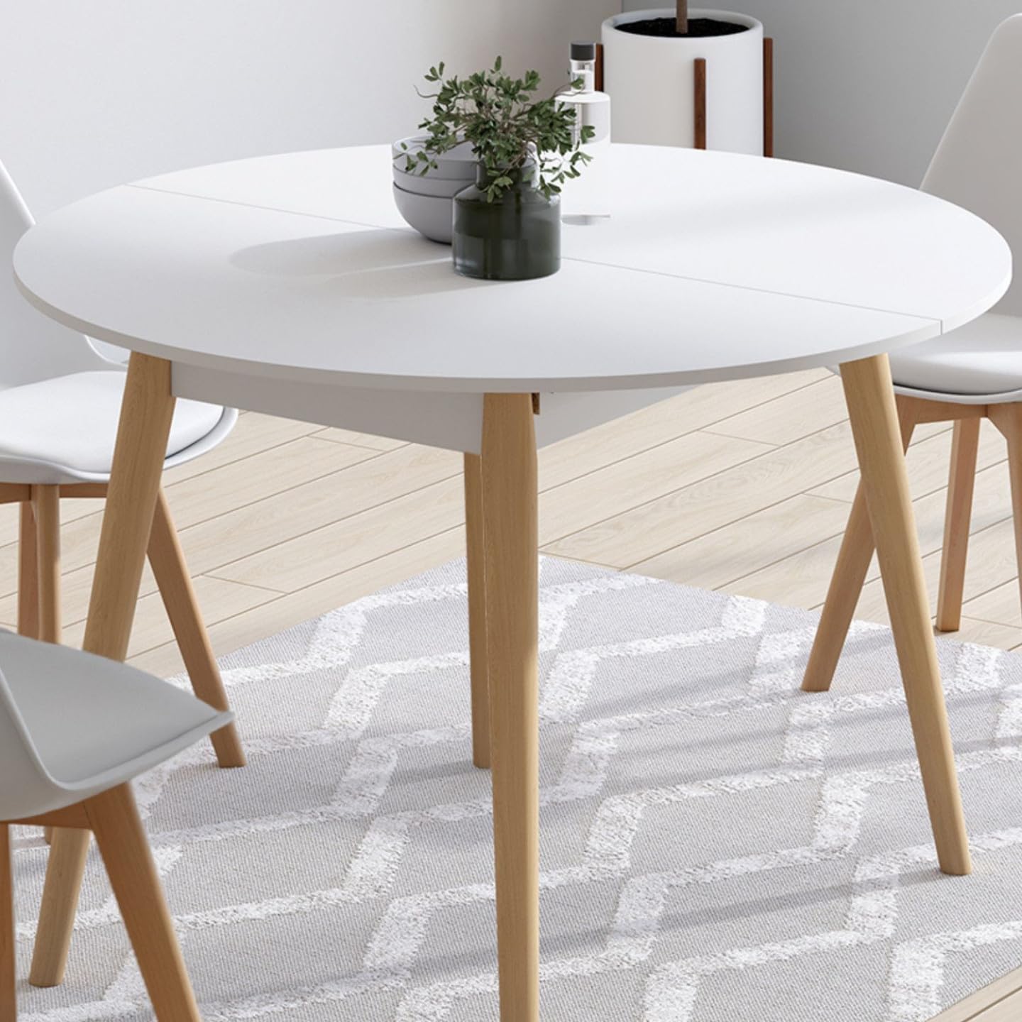 IDMarket Angela – Mesa de comedor extensible redonda para 4 – 10 personas, color blanco y pie madera 110 – 200 cm