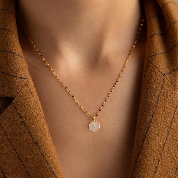 Close-up of the Patwes dainty 14K gold-plated cross pendant necklace, showcasing its minimalist design and adjustable chain.