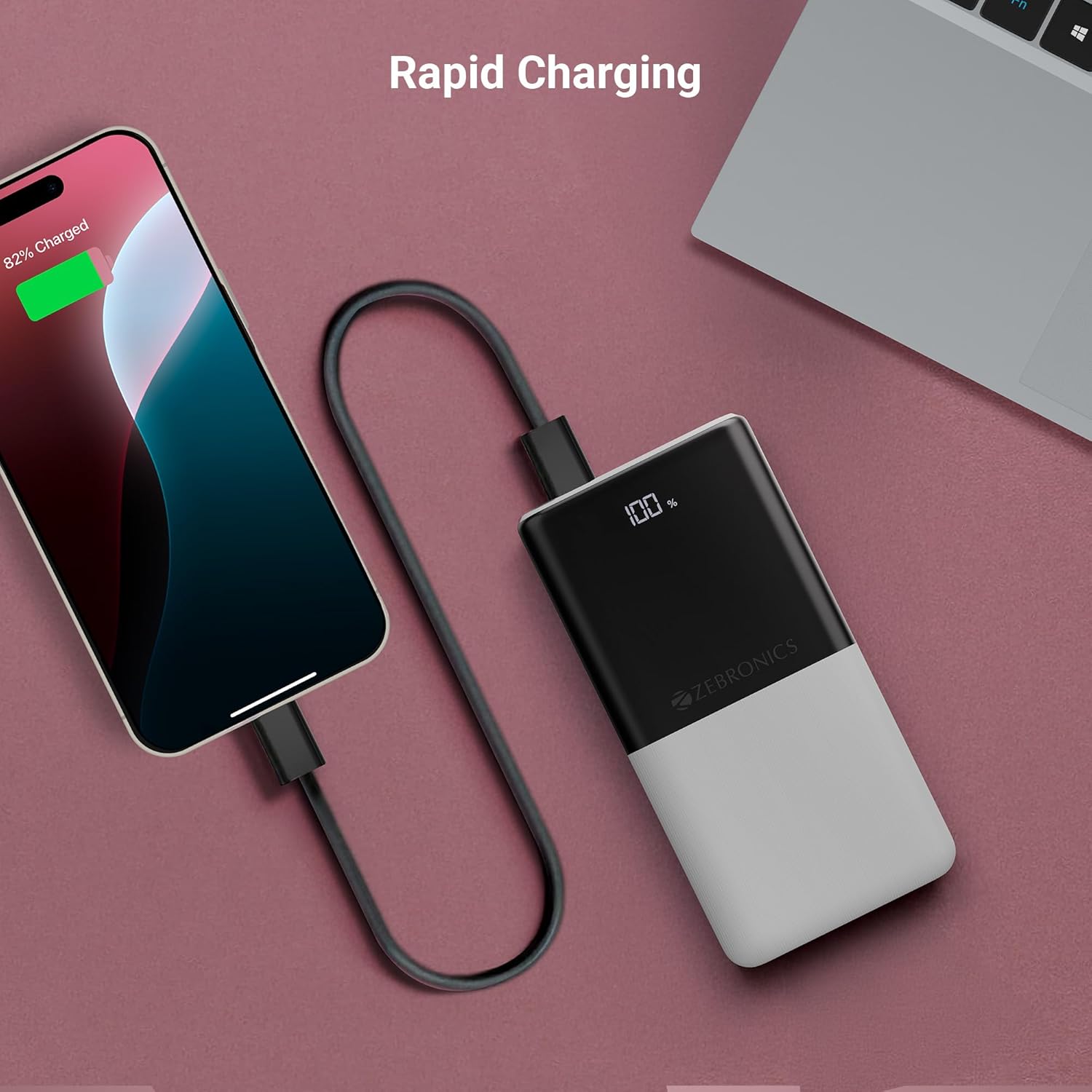 ZEBRONICS EnergiPod 10R1 Power Bank connected via cable to a smartphone, both showing charging status.