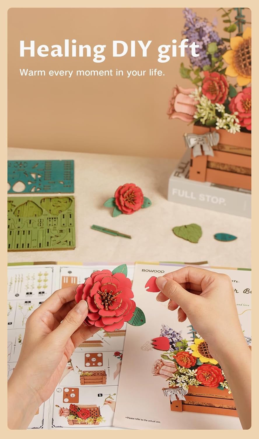 Hands arranging wooden flowers and greenery into the perforated top of the wooden bloom box, demonstrating customization.