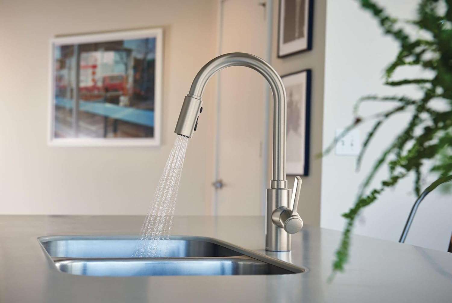 Moen Genta LX faucet dispensing a powerful spray of water into a sink