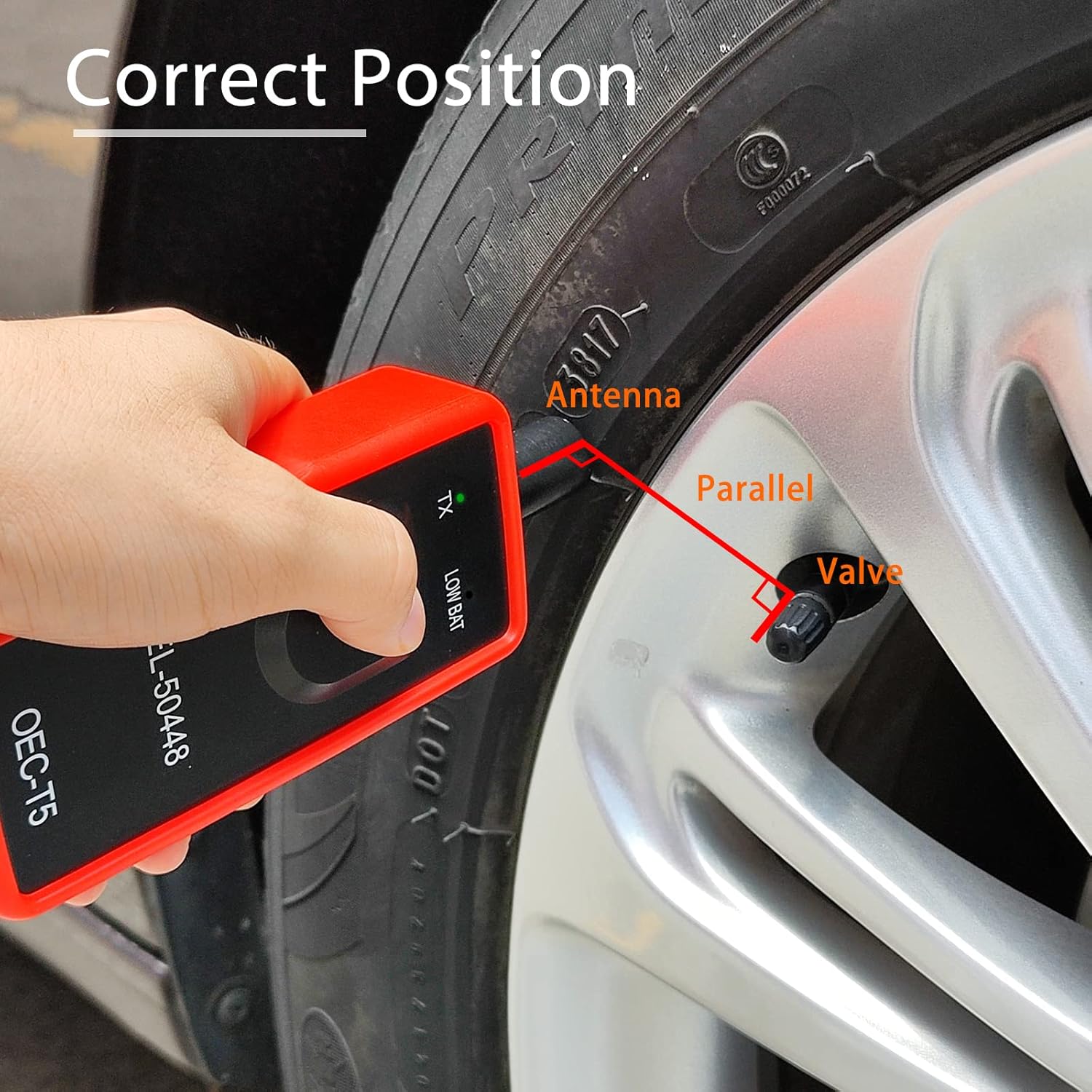 Hand holding EL-50448 tool against tire sidewall near valve stem