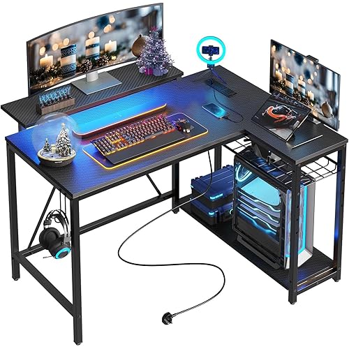 Bestier Gaming Desk with Power Outlets, 42" L-Shaped Computer Desk with LED Lights, Desk with Reversible Storage Shelves & Hooks for Small Spaces, Bedrooms & Offices, Black Carbon Fiber