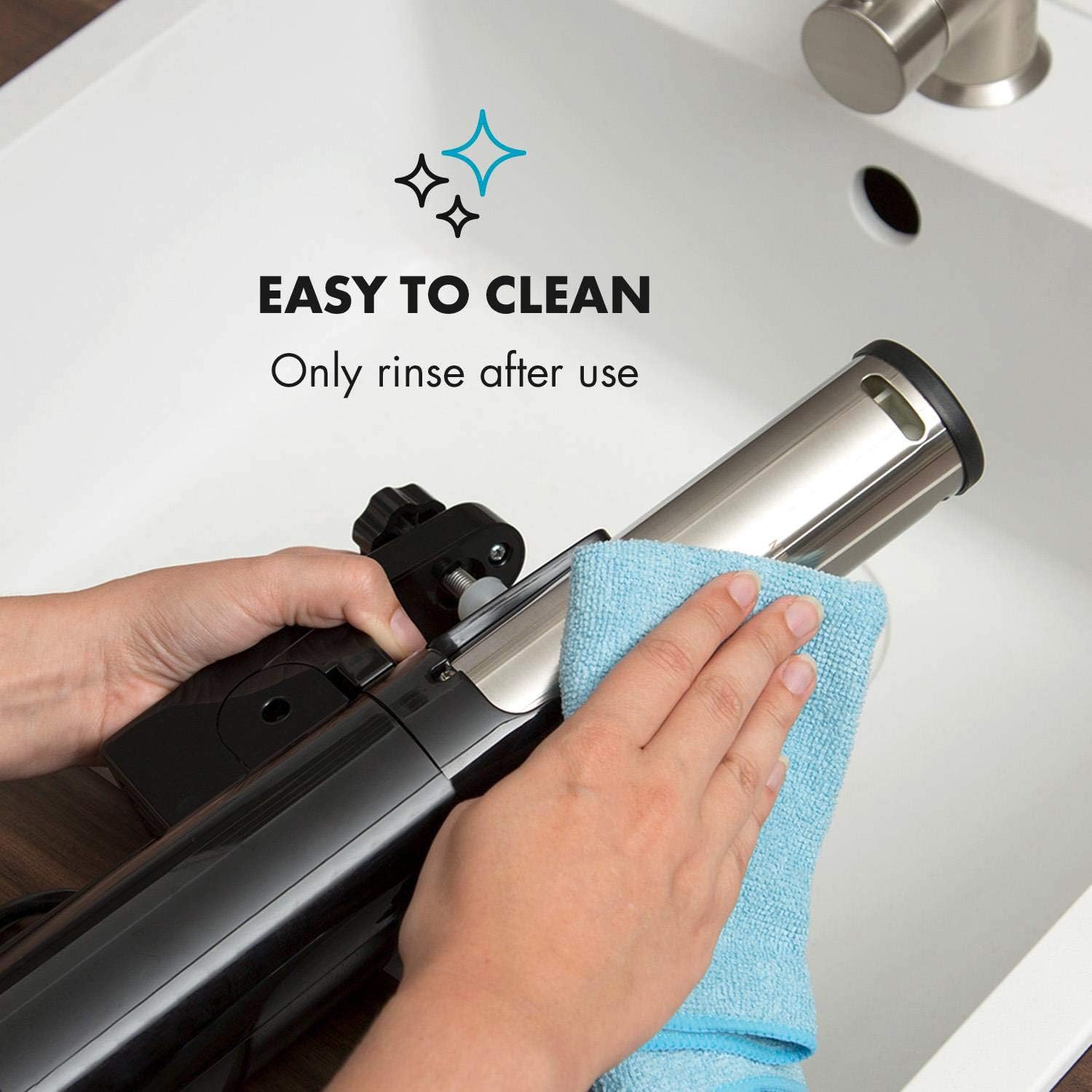 Hands cleaning the sous vide immersion cooker under a faucet