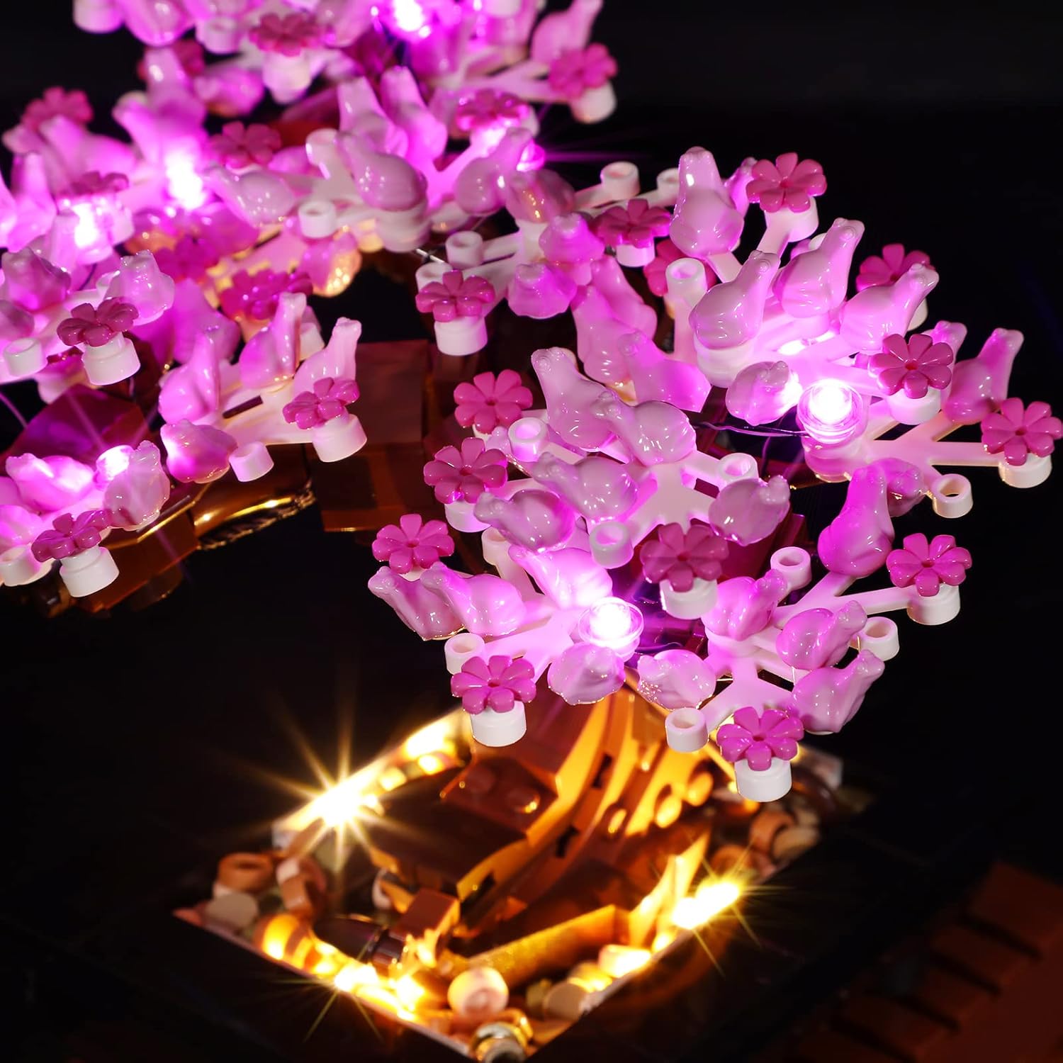 Close-up of the illuminated pink blossoms on the LEGO 10281 Bonsai Tree with BRIKSMAX LED lights.
