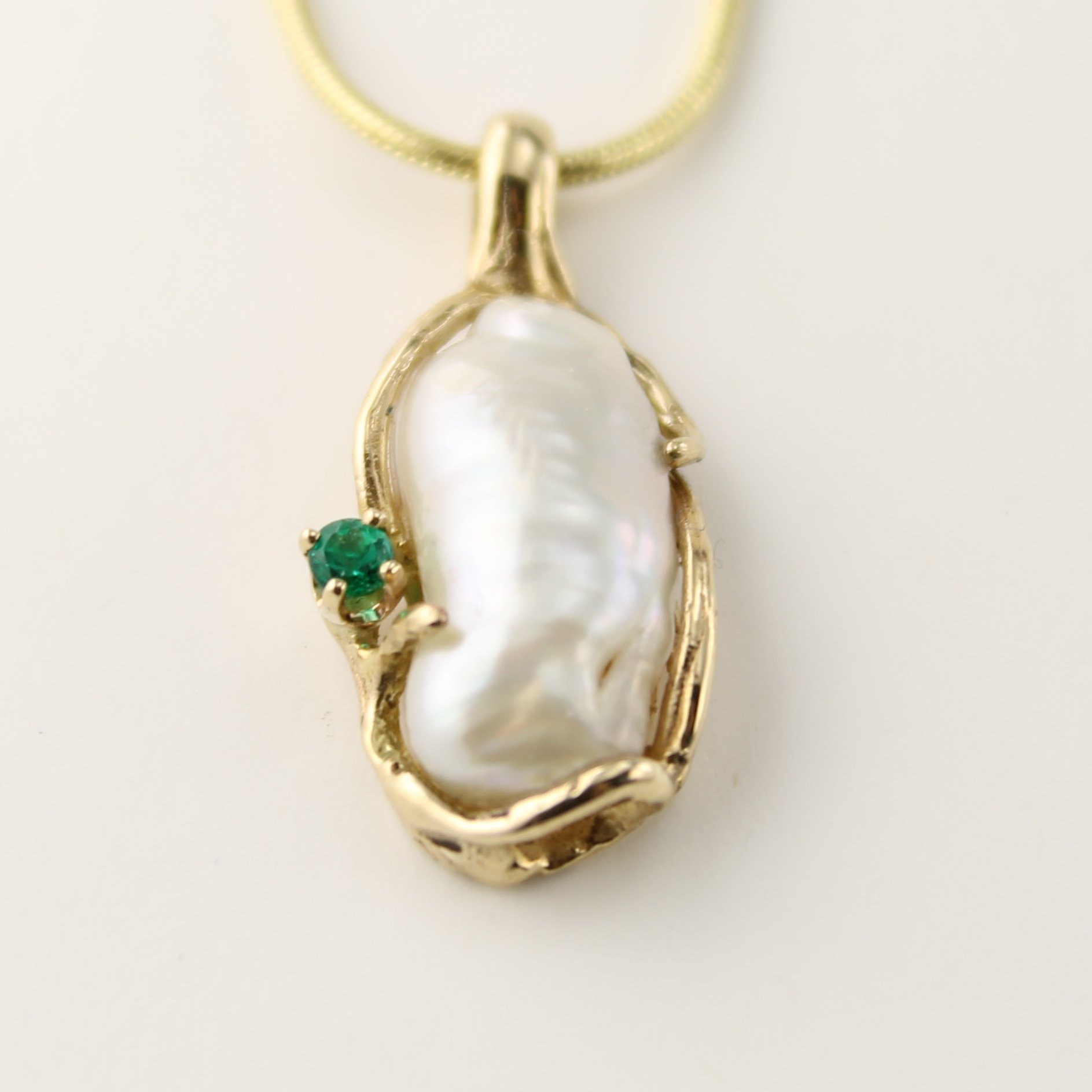 14 Karat Yellow Gold Free-Form Pendant featuring a Biwa Pearl accented with a natural Columbia Emerald.