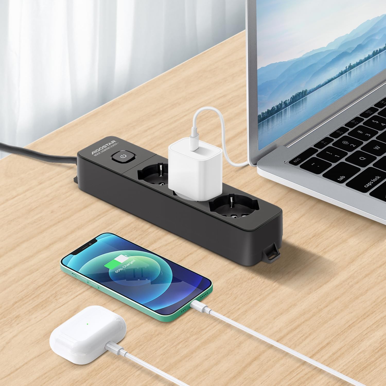 Aigostar Power Strip in use with laptop and phone