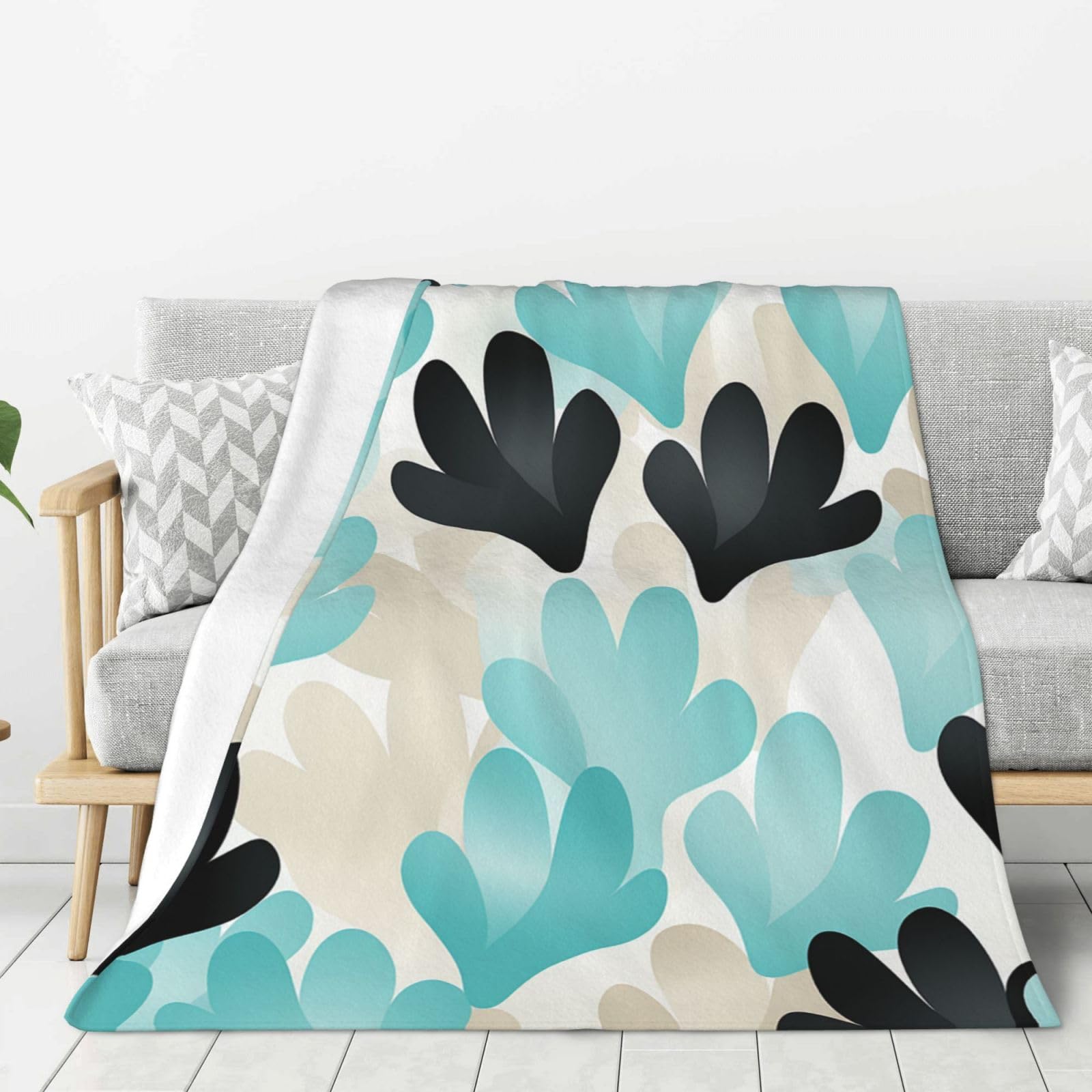 Couverture en flanelle douce pour soirée cocooning sur le canapé du salon