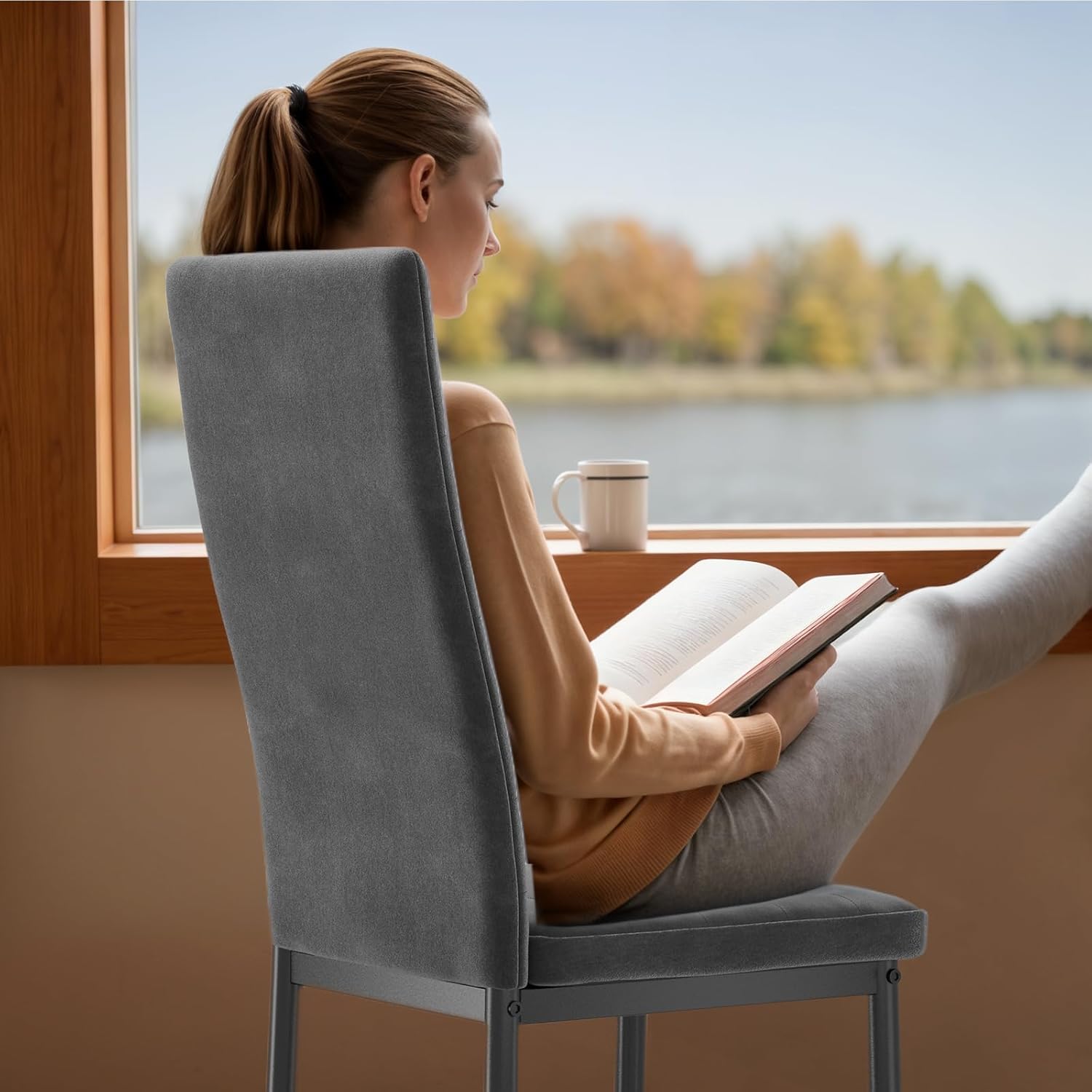 A person sitting on a dark grey dining chair at a desk, illustrating ergonomic posture support.