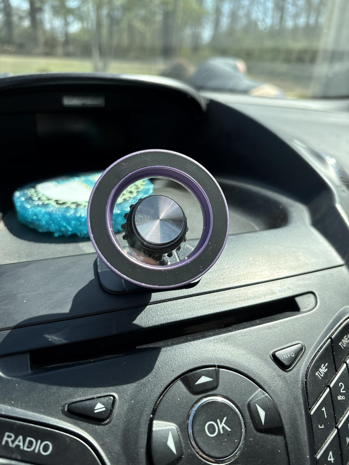 MagSafe car mount assembled and installed on car dashboard, purple color