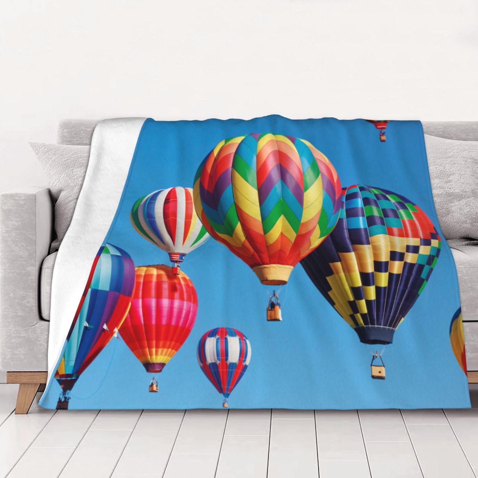 Plaid flanelle montgolfière pour des soirées cocooning confortables dans le canapé