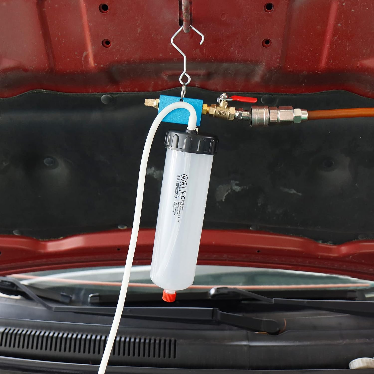CCLIFE Brake Fluid Bleeder suspended under a car hood, connected and ready for use.